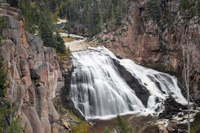 waterfall among cliffs in Yellowstone National Park