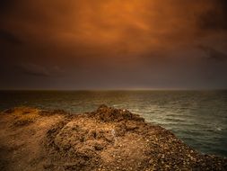 sunset over the sandy coast of the ocean