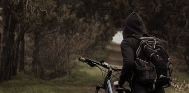 cyclist in the gloomy forest