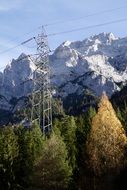 power lines on a background of snowy Alpine mountains