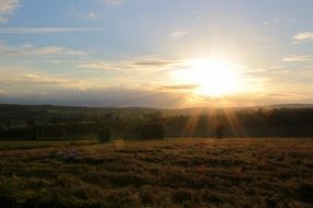 the setting sun over the horizon at dusk