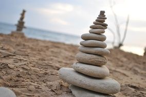 Stone statue on a sand beach