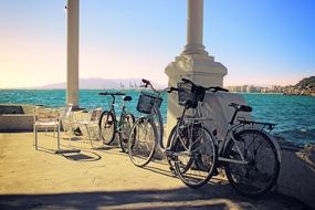 bicycles at fence in view of sea, spain, malaga