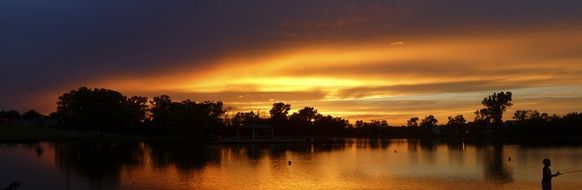Fishing on a lake at sunset