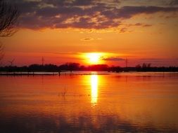 Sunset Afterglow in evening sky mirroring on calm water