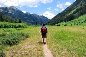 tourist with a red backpack in the mountains of colorado