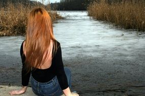 girl with long hair near a frozen lake