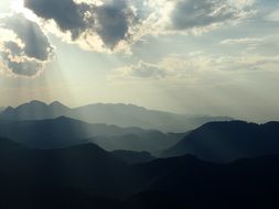 sunlight over the mountains of laos at dusk