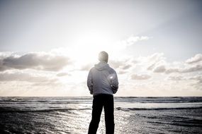 man on a tropical beach at sunset