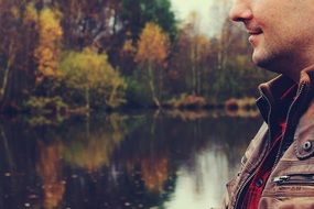 photo of a man on the background of the lake