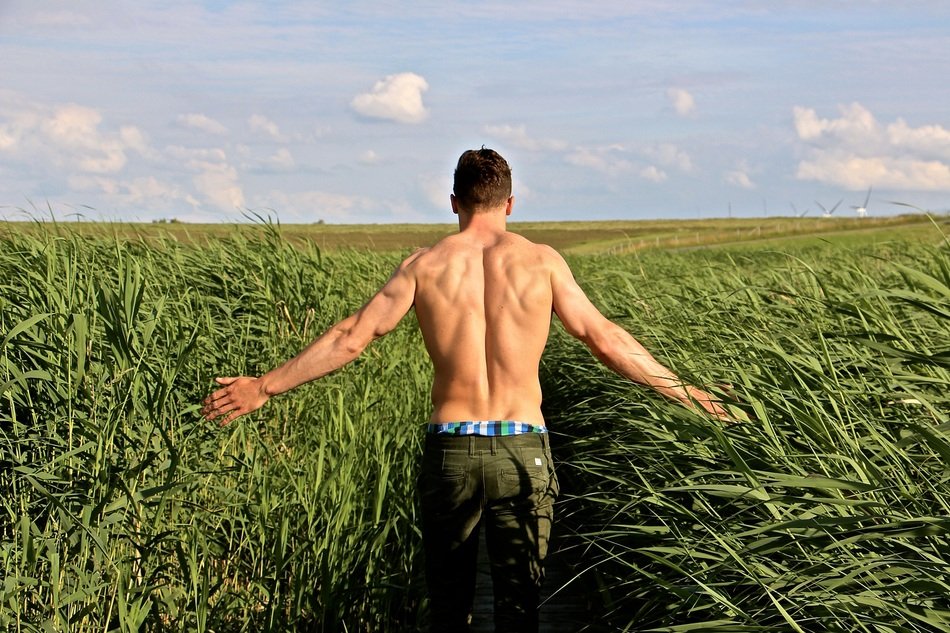athlete in the midst of tall grass