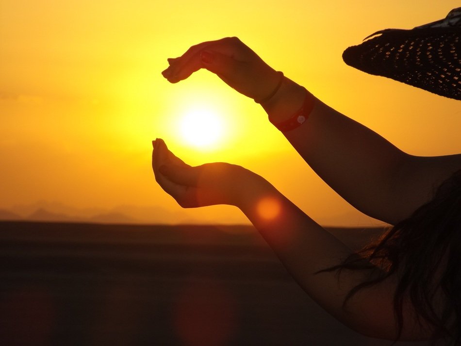 Holding beautiful and colorful sunset in hands