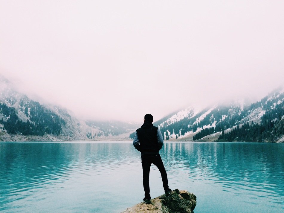 Person Looking at Mountain Lake