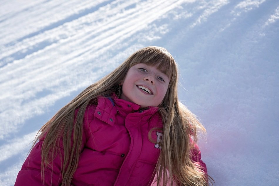 Blonde girl with long hair on the beautiful, white snow