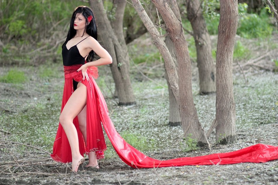girl with red attributes in the forest