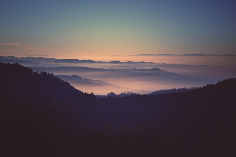 view of mountains in the fog in switzerland