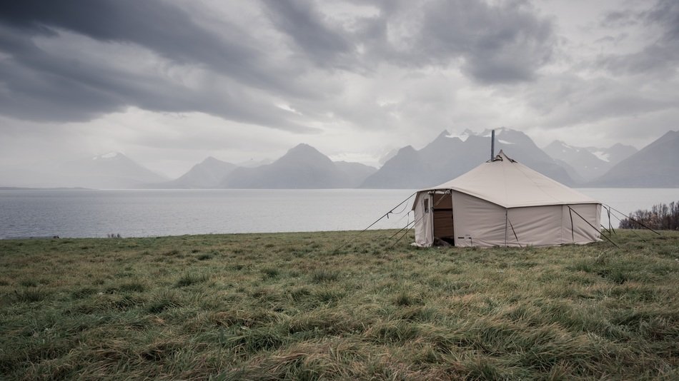 white Tent at fjord under stormy clouds, norway, Lyngen