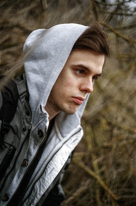 young man in the hood among the nature
