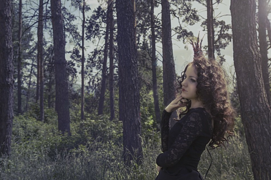 Girl in the black dress in the forest
