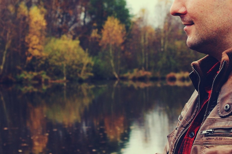 photo of a man on the background of the lake