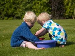 children play on green grass