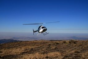Helicopter flying over the Mountains