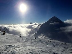 people skiing on mountain side at clouds, Winter landscape