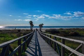 long wooden bridge to the beach in spain