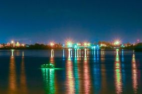 colorful Night city lights mirroring on sea