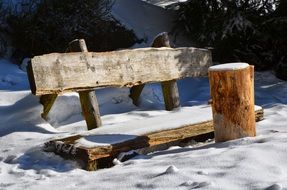 wooden bench in the snow