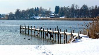 wooden pier on chiemsee lake at winter, germany, bavaria