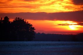 snow landscape against a bright orange sunset