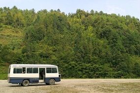 parked tourist bus on the background of the hill