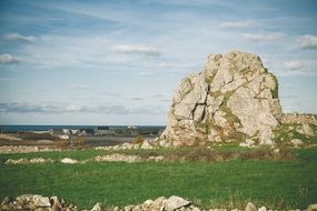 rock on a green field in Oderville, France