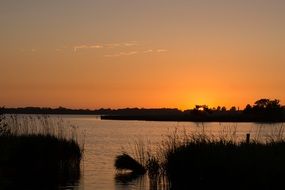 Sunset on the horizon on the lake