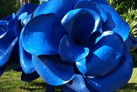 bright blue flowers like sculptures in a park among the plants
