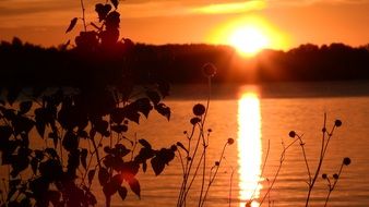 orange sunset over the lake at dusk