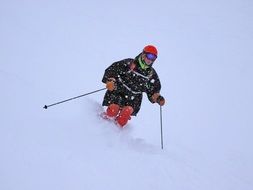 skier goes down the snow from the mountain