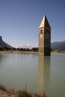 high tower in the middle of a lake in South Tyrol