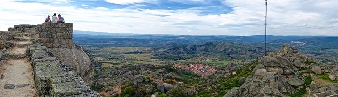 people on the ruins of a fortress in the mountains