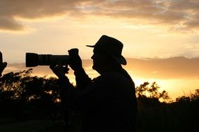 silhouette of a photographer at sunset