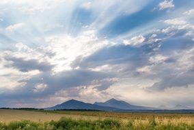 distant view of the mountains under a cloudy sky