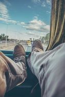 Travel, male legs at Bus window