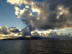 rays of light behind the clouds above the lake