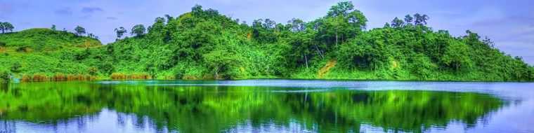 panoramic view of a mountain lake near green hills