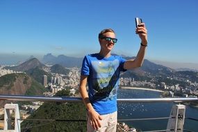 young man taking Selfie in view of city, brazil, Rio De Janeiro