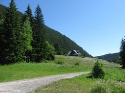 distant view of a house on a hill in the mountains on a sunny day