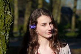 photo of a girl with a cornflower in her hair