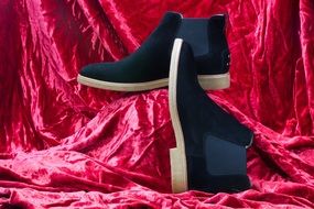 photo of black shoes on pink fabric