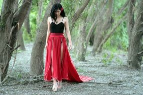 girl in a red skirt in the forest